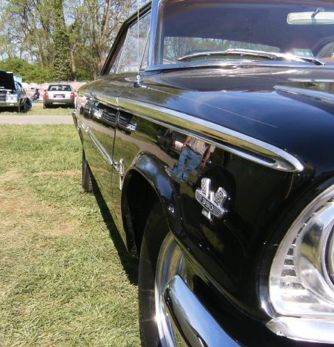 1963 Ford Galaxie - Close-up of a black 1963 Ford Galaxie 330, highlighting its distinctive fender badge and chrome accents.