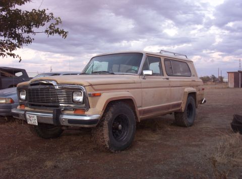 1988 Ford Bronco - This Jeep Wagoneer, likely from the early 1980s, is seen in a three-quarter front view with aftermarket wheels and a roof rack.
