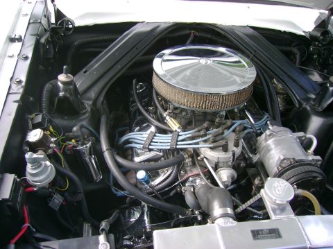 1965 Ford Falcon - Close-up of a V8 engine bay, a chrome air cleaner and visible engine components.
