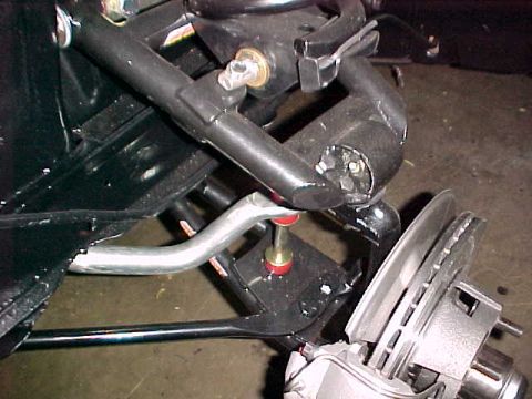 1968 Shelby GT350 - This image shows a close-up view of a vehicle's front suspension system, focusing on the brake assembly.