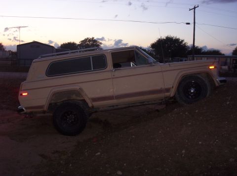 1988 Ford Bronco - This Jeep Cherokee Chief is angled on a dirt mound as the sun sets.
