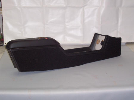 1968 Shelby GT350 - A black car center console with a textured finish and a padded armrest is shown against a white backdrop.
