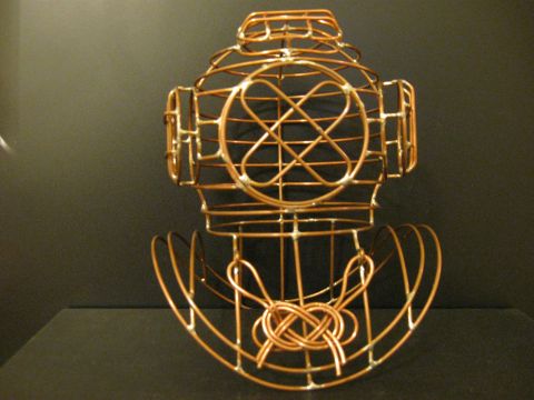 1989 Ford Bronco - A copper wire sculpture resembling a vintage diving helmet is displayed against a dark background.