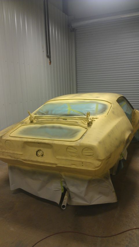 1973 Chevrolet Camaro - A car body, likely from the 1970s, is prepared for painting in a workshop.