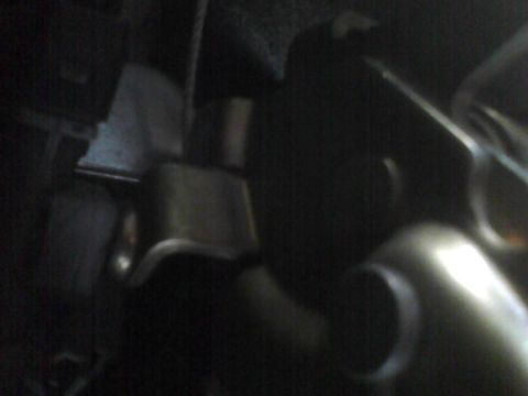 2003 Ford Crown Victoria - A dark, close-up view of various engine components within a vehicle's engine bay.