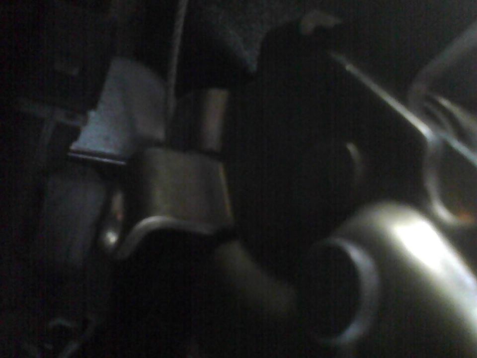 Close-up of engine bay parts, possibly a radiator hose and fan shroud