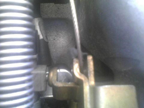 2003 Ford Crown Victoria - A detailed view of engine components, including a cable and spring, is visible in this close-up shot.