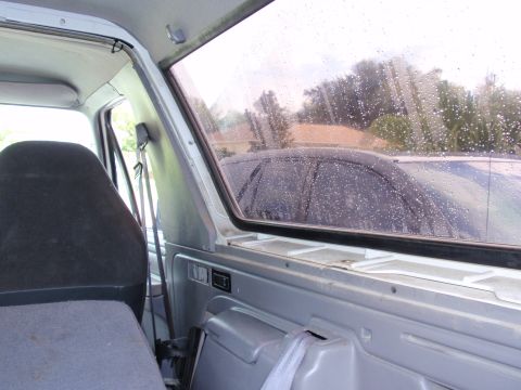 1995 Ford Bronco - Interior view of a 1995 Ford Bronco, showing the removable top section and a glimpse of another vehicle outside.