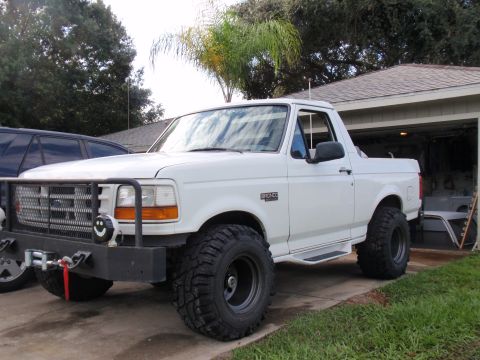 1995 Ford Bronco - This white Ford Bronco is equipped with off-road tires and a custom front bumper with a winch.