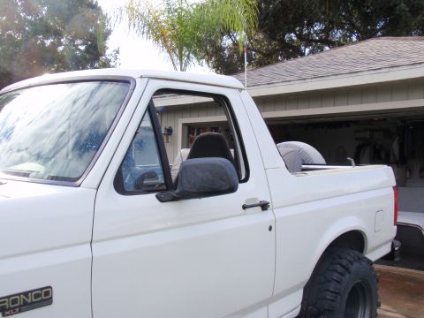 1995 Ford Bronco - The side profile of a white Ford Bronco XLT reveals its distinctive body style, suggesting a model year earlier than claimed.