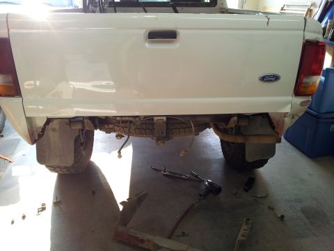 1994 Ford Ranger - The rear of a white Ford Ranger pickup truck is shown, with the spare tire visible underneath.