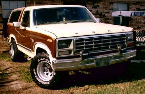 1980 Ford Bronco - This Ford Bronco features a two-tone paint scheme with wood grain trim and aftermarket wheels.