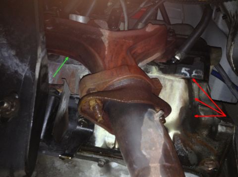 1993 Ford Bronco - Close-up view of an exhaust manifold attached to an engine block, with a visible '58' marking on the block.
