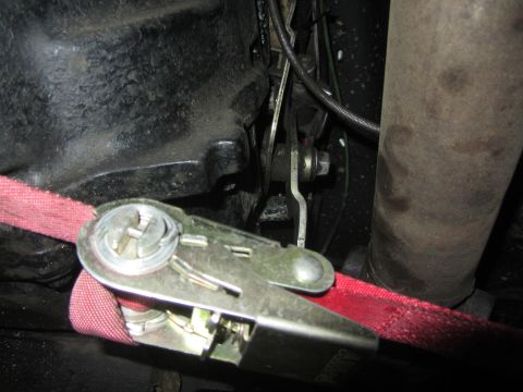1997 Dodge 3500 - Close-up view of a vehicle's transfer case, secured with a red ratchet strap.