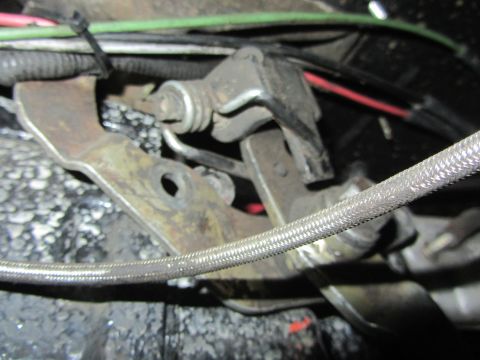 1997 Dodge 3500 - This is a close-up view of the transfer case linkage mechanism, showing various cables and metal components.