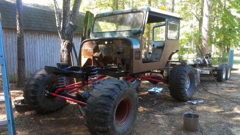 1978 Ford Bronco - This custom build features oversized tires and a heavily modified suspension system, appearing to be in a state of construction.