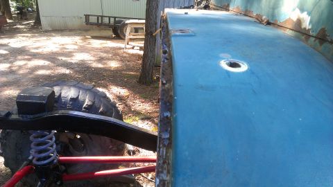 1978 Ford Bronco - Detail of vehicle body and suspension system, with a large off-road tire visible.