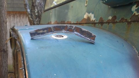 1978 Ford Bronco - A close-up view of a blue 1978 Ford Bronco fender, showing a metal bracket and signs of rust.
