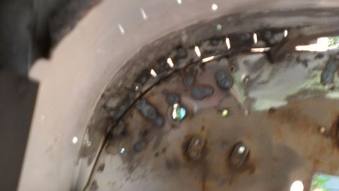 1978 Ford Bronco - Metal panel showing spot welds and drilled holes, likely undergoing repair or modification.