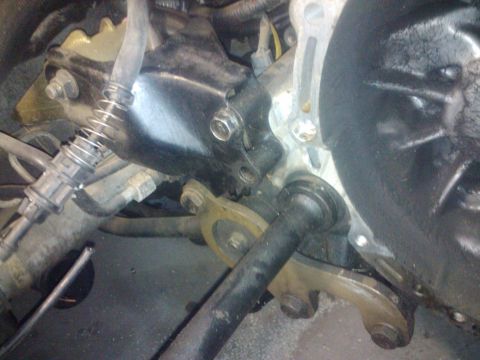 1995 Ford Probe - Close-up view of engine bay components, including hoses and mounting brackets.