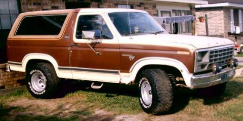 1980 Ford Bronco - This two-tone brown and white 1980 Ford Bronco is shown from a three-quarter front angle.