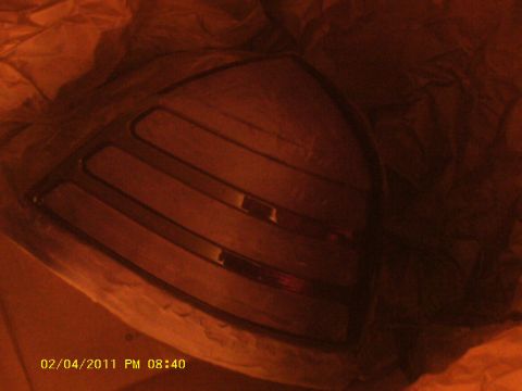 1998 Ford Crown Victoria - A single taillight assembly, likely for a car, is partially visible, wrapped in material.