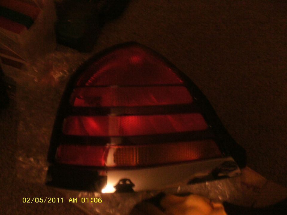Close-up of a red car tail light assembly with horizontal amber turn signal section
