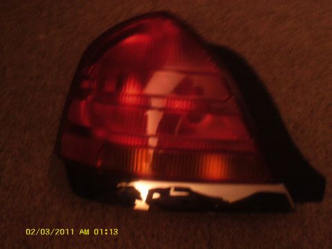 1998 Ford Crown Victoria - A red taillight assembly, likely from a sedan, is shown in this close-up view.