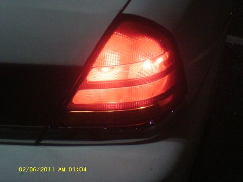 1998 Ford Crown Victoria - Vehicle taillight assembly is illuminated red in this close-up shot.