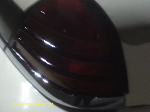 1998 Ford Crown Victoria - A close-up view of a vehicle's taillight assembly, showing its distinct red and clear sections.