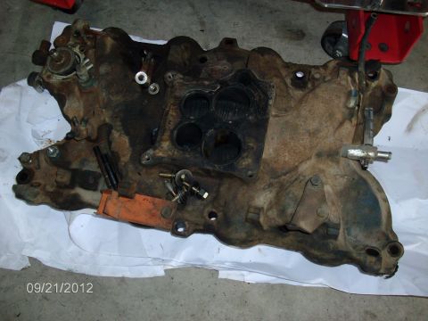 1979 Ford F-150 - This intake manifold appears to be a used part, showing significant rust and wear.