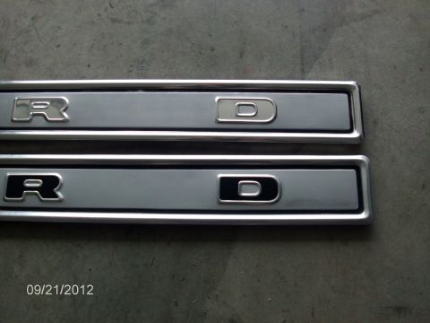 1979 Ford F-150 - Two Ford emblems are shown, one with a silver outline and the other with a black outline.