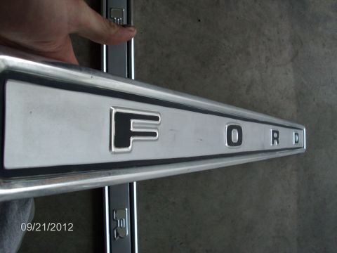 1979 Ford F-150 - Close-up of a silver Ford emblem with black lettering, likely from a 1979 Ford F-150.