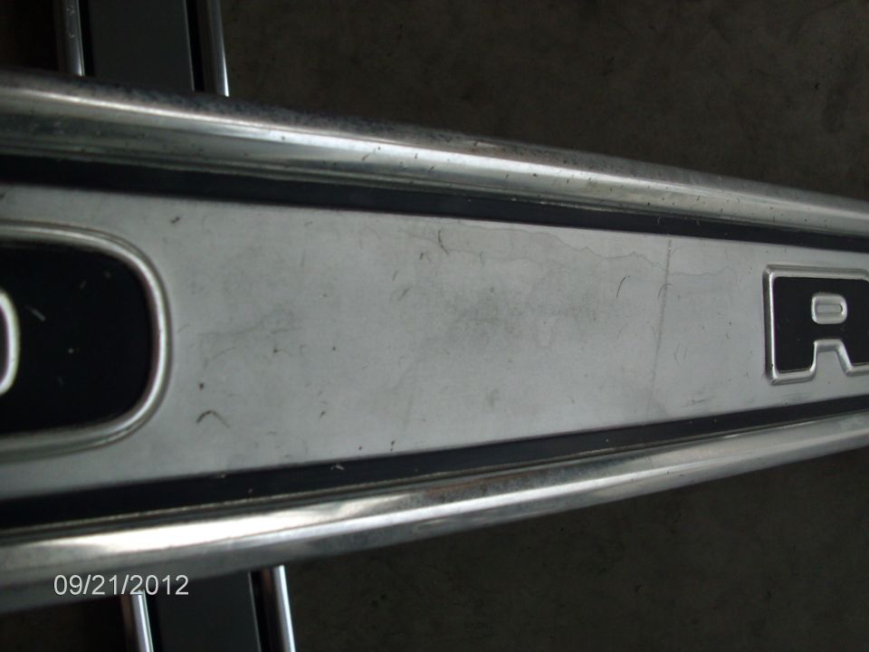 Chrome trim piece with letters 'D' and 'R' visible
