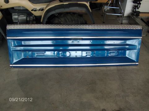 1979 Ford F-150 - This blue tailgate with prominent "FORD" lettering and chrome trim appears to be from a 1979 Ford F-150.