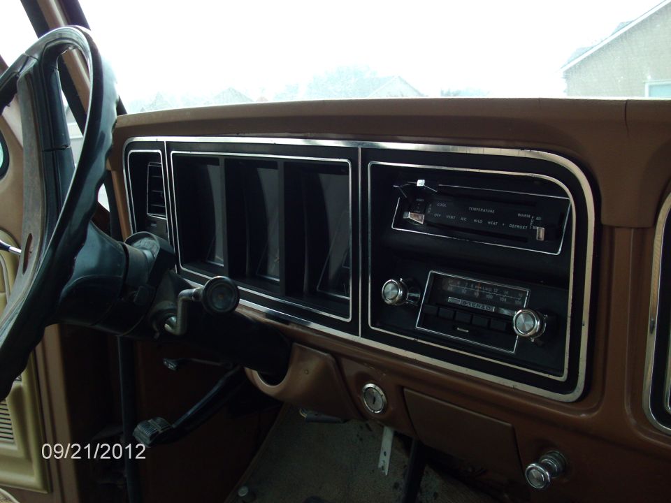 1979 Ford F-150 dashboard with brown trim, radio, and steering wheel