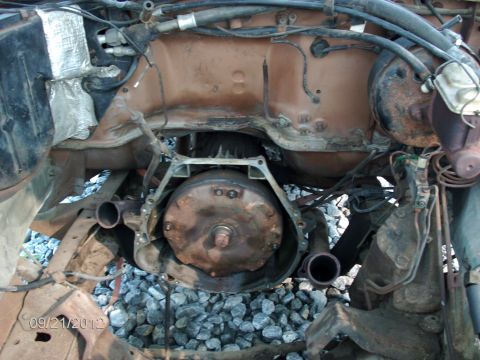 1979 Ford F-150 - The transmission and engine bay of a 1979 Ford F-150 show significant wear and tear.