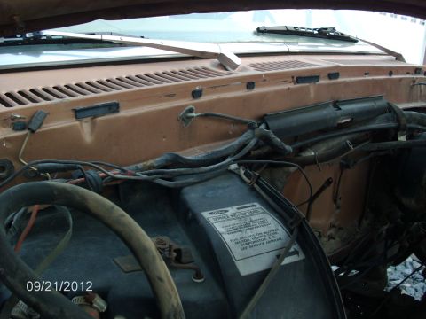 1979 Ford F-150 - A close-up view of a vehicle's engine bay, revealing various components and a service instruction label.