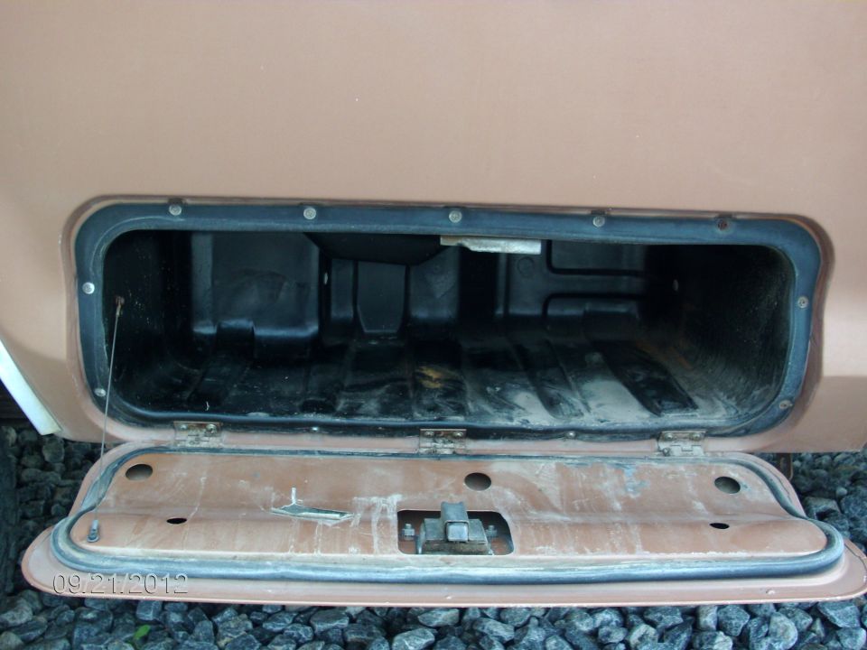 1979 Ford F-150 bed storage compartment open, showing interior and latch mechanism