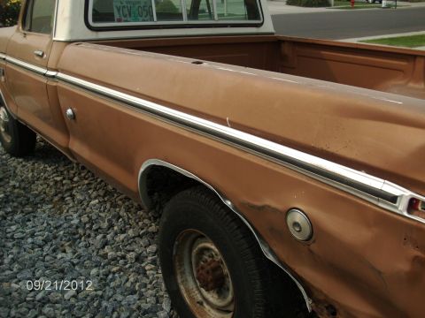 1979 Ford F-150 - This pickup truck has a two-tone paint scheme with brown and white colors.