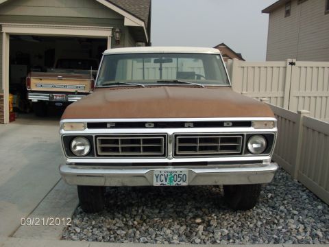 1979 Ford F-150 - A 1979 Ford F-150 is parked in front of a garage, with another Ford truck visible inside.