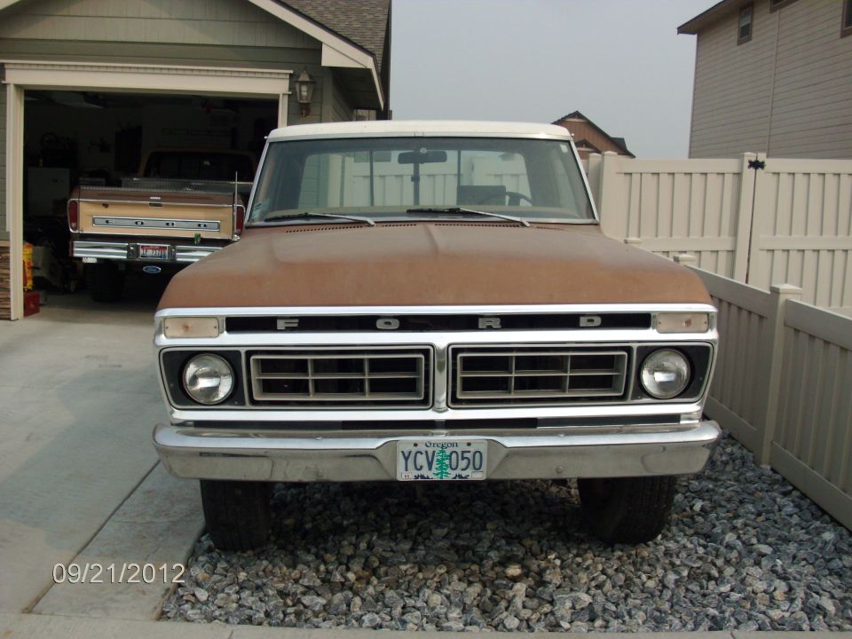 Front view of a brown 1979 Ford F-150 with a white roof and a license plate reading YCV 050