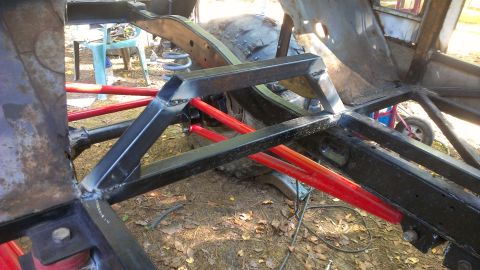 1978 Ford Bronco - Custom metalwork is being performed on a vehicle's frame, with red suspension parts visible.