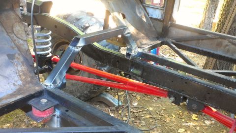 1978 Ford Bronco - Custom off-road vehicle frame under construction with visible suspension components and a large tire.