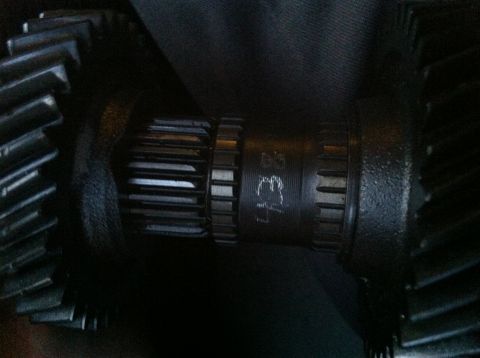 1993 Ford Probe - Close-up view of two dark metal gears, one showing splines and stamped markings.