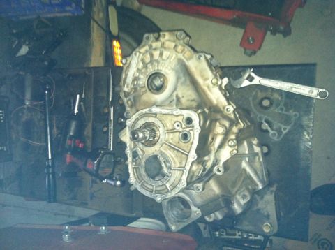 1993 Ford Probe - A transmission component is shown disassembled on a workbench with tools.