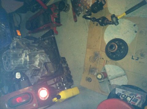 1993 Ford Probe - Various automotive parts, including an engine and transmission, are laid out on the floor.