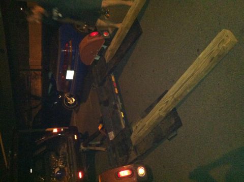 1993 Ford Probe - A blue car is parked at night, with wooden beams in the foreground.