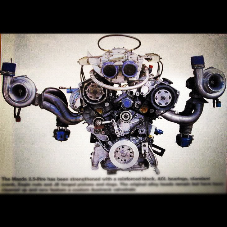 Twin-turbocharged V6 engine with dual carburetors and prominent exhaust manifolds