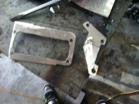 1993 Ford Probe - Metal parts are laid out on a workbench, possibly for fabrication or repair.